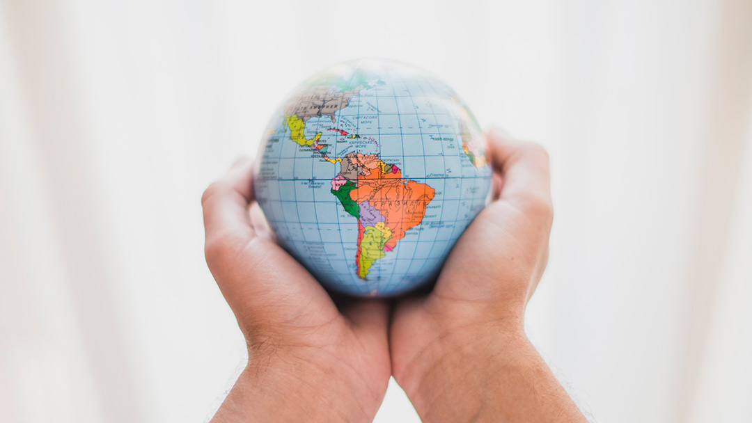Hands holding a globe