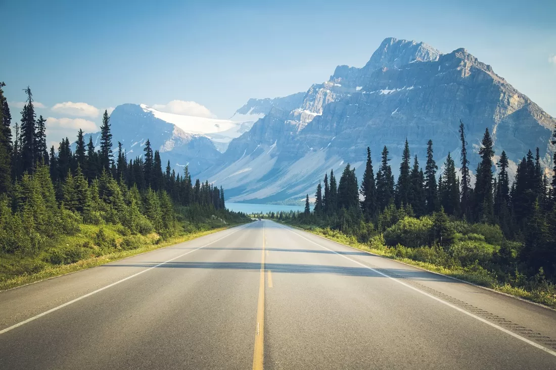 highway in canada with mountains in the background